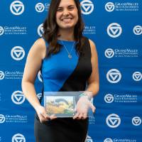 Emily poses with award